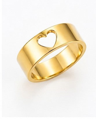JOYAS gold-toned band ring featuring a minimalist heart-shaped cutout design on a polished metal surface.